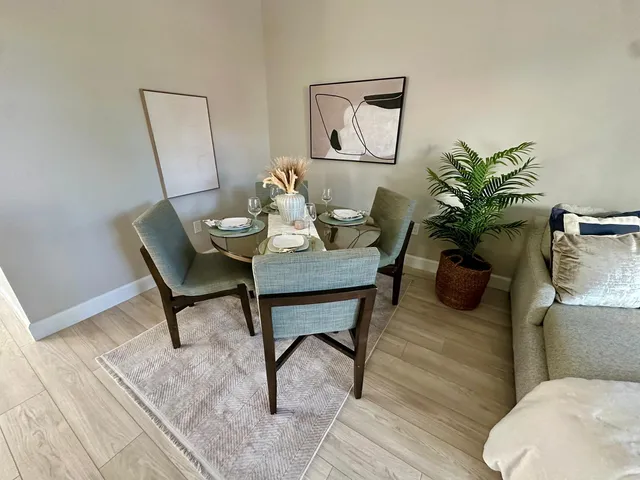 a living room with furniture and a potted plant