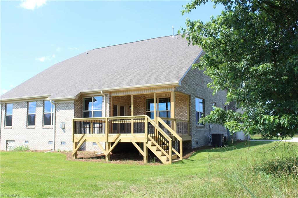 2625 Lunsford Road Summerfield, NC 27358 - Photo 27 of 30 Covered porch and deck - huge backyard!