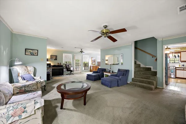 a living room with furniture and a chandelier