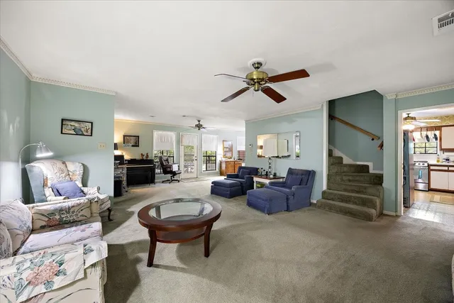 a living room with furniture and a chandelier