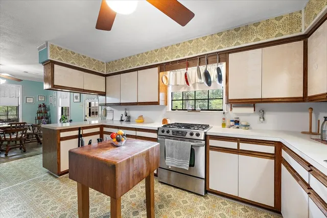 a kitchen with stainless steel appliances granite countertop a stove a sink and a refrigerator