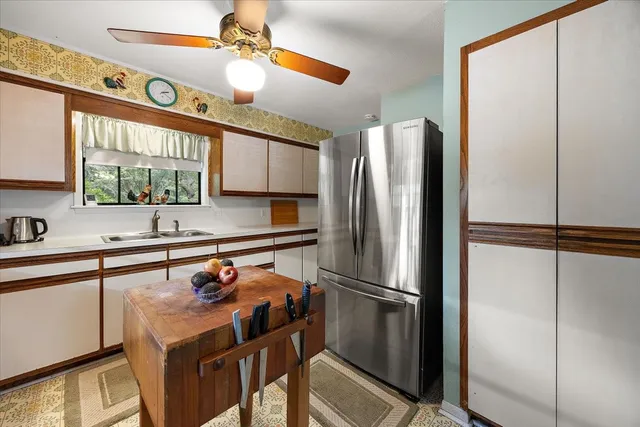 a kitchen with stainless steel appliances a refrigerator and a sink