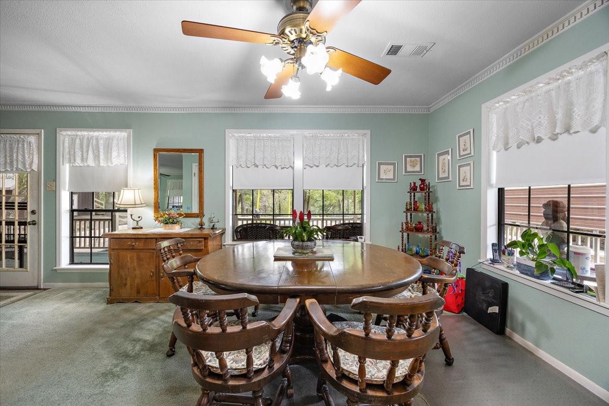 450 Four Notch Road Huntsville, TX 77340 - Photo 15 of 49 a view of a dining room with furniture window and wooden floor