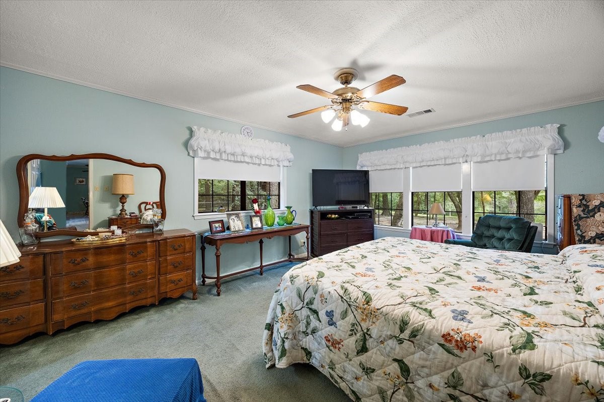 450 Four Notch Road Huntsville, TX 77340 - Photo 16 of 49 a bed room with a bed and a television