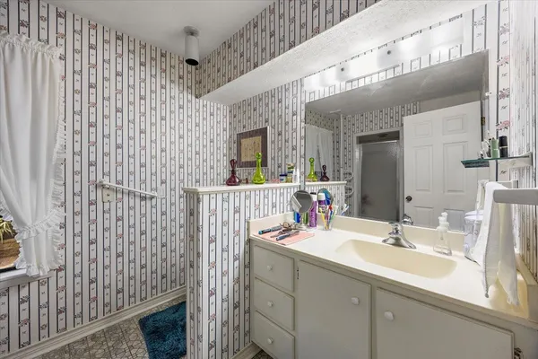 a bathroom with a sink a vanity and a mirror