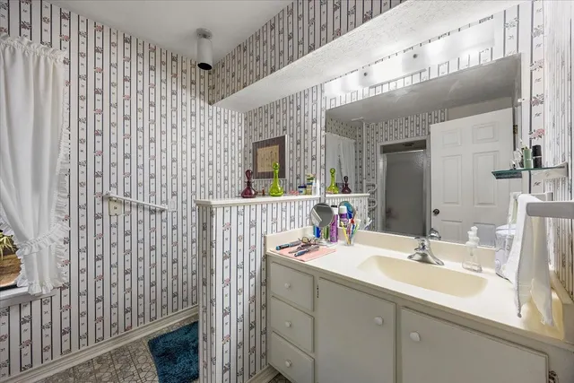 a bathroom with a sink a vanity and a mirror