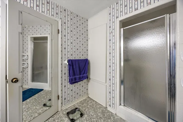 a bathroom with a shower and a mirror