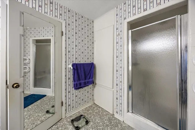 a bathroom with a shower and a mirror