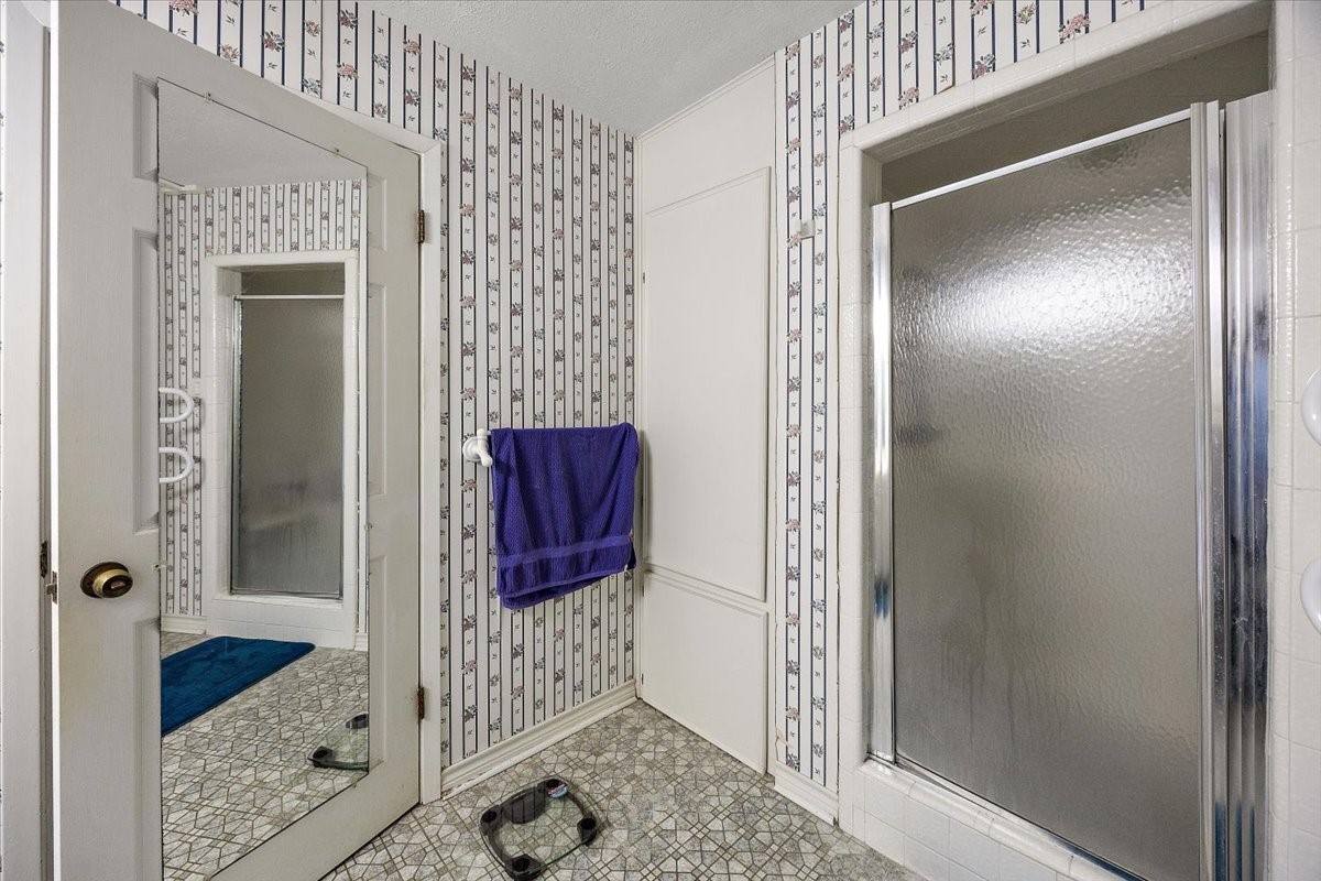 450 Four Notch Road Huntsville, TX 77340 - Photo 19 of 49 a bathroom with a shower and a mirror