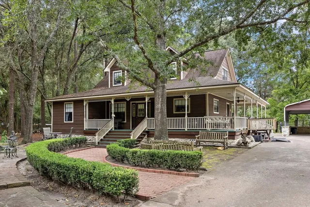 a front view of a house with garden and porch