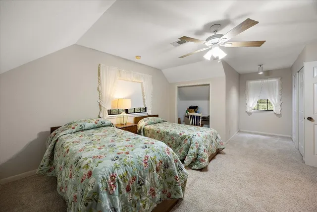 a bedroom with two beds and a chandelier