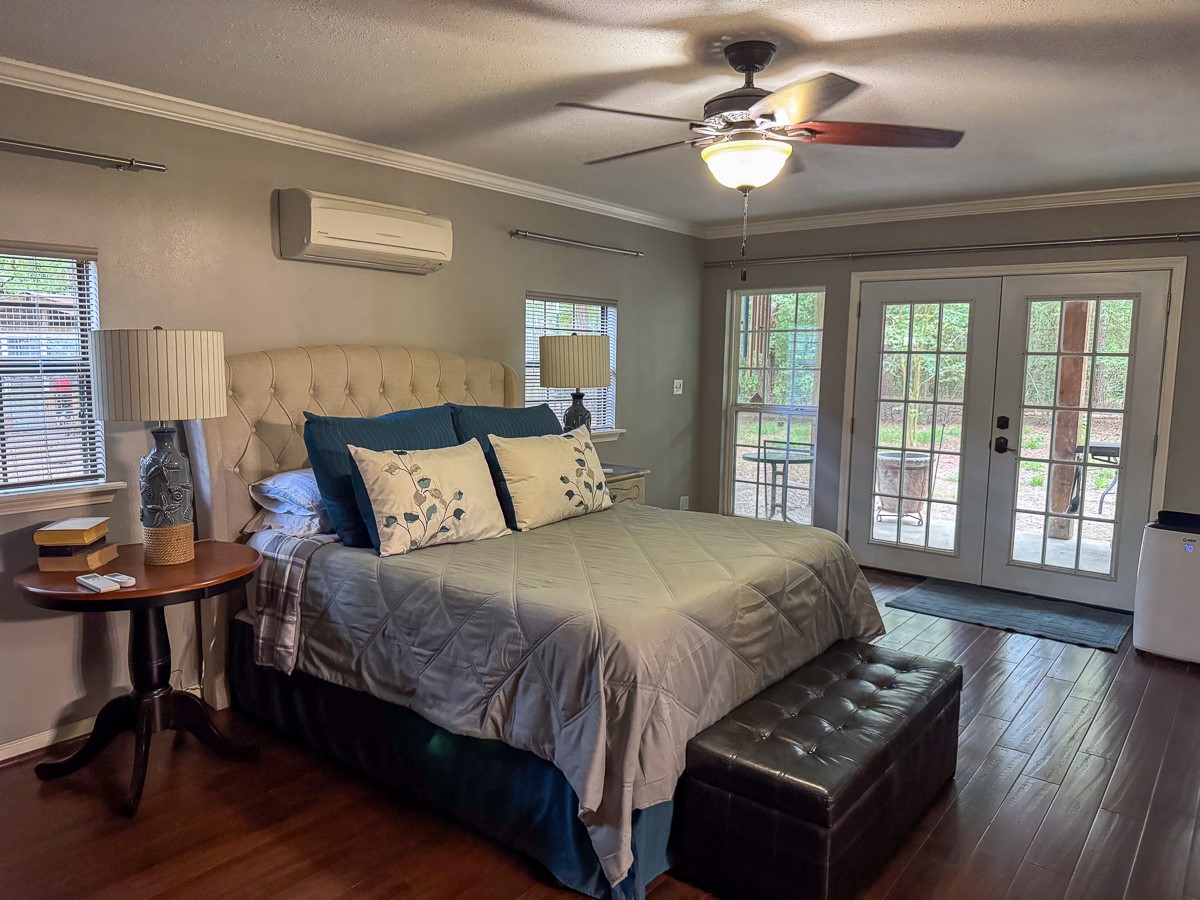 450 Four Notch Road Huntsville, TX 77340 - Photo 27 of 49 a bed sitting in a bedroom next to a window