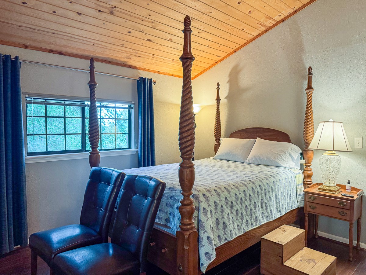 450 Four Notch Road Huntsville, TX 77340 - Photo 30 of 49 a bedroom with a large bed and windows