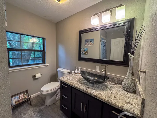 a bathroom with a toilet sink and mirror
