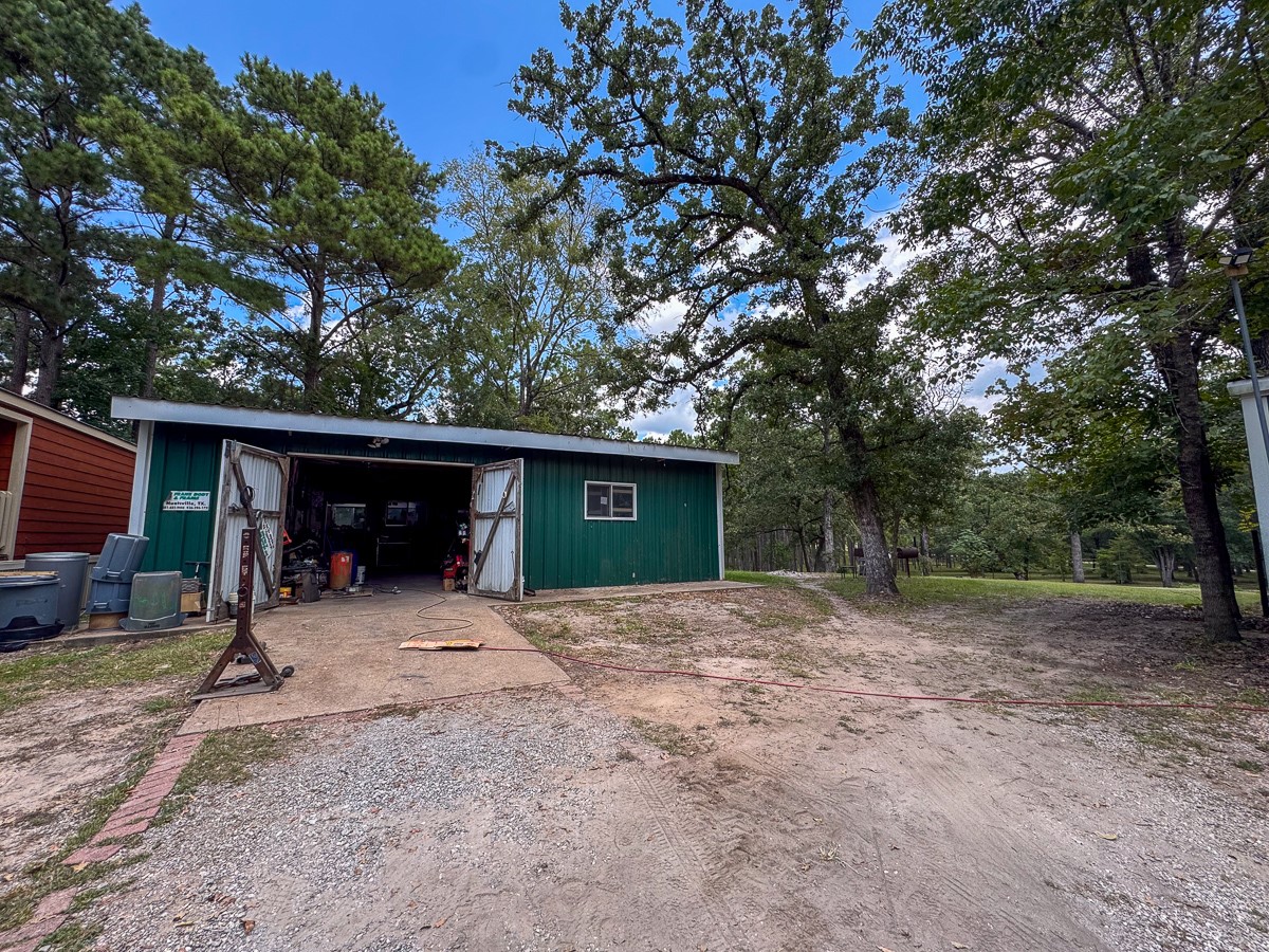 450 Four Notch Road Huntsville, TX 77340 - Photo 35 of 49 a view of a house with a tree in the background