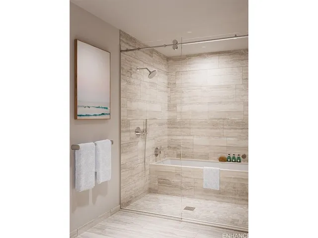 a bathroom with a glass shower door