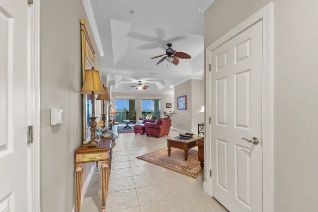 a view of a livingroom with furniture and a ceiling fan