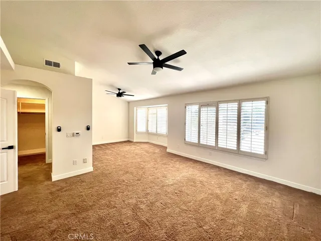a view of a livingroom with a ceiling fan and window