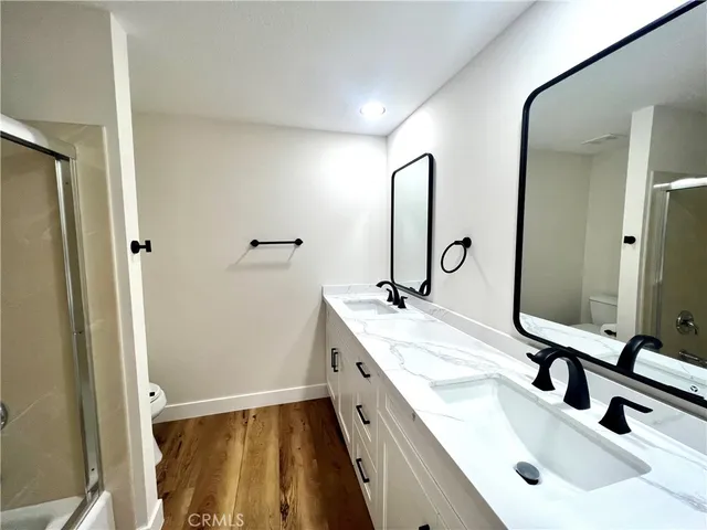 a bathroom with a double vanity sink and mirror