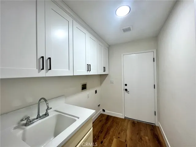a kitchen with a sink and cabinets