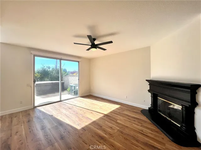 a view of a livingroom with a ceiling fan and wooden floor