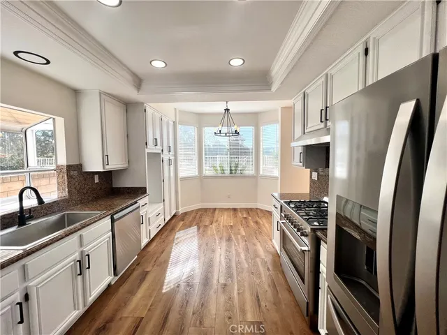 a kitchen with stainless steel appliances a sink stove and refrigerator