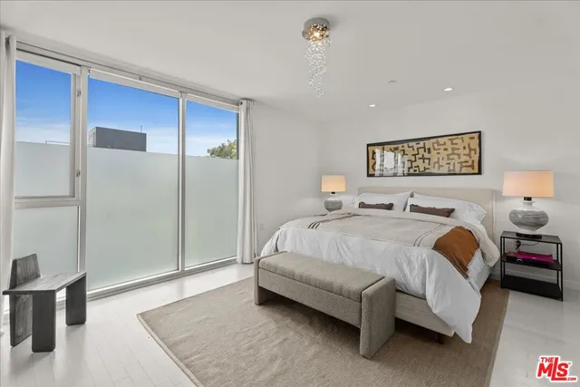 a spacious bedroom with a bed and a table