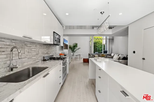 a large white kitchen with a large window