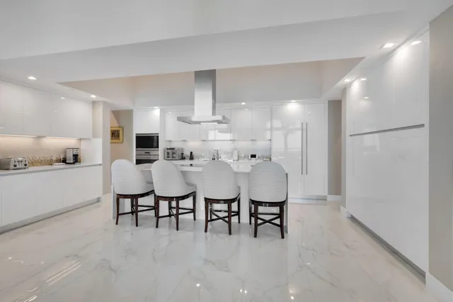 a bathroom with a granite countertop toilet sink and mirror