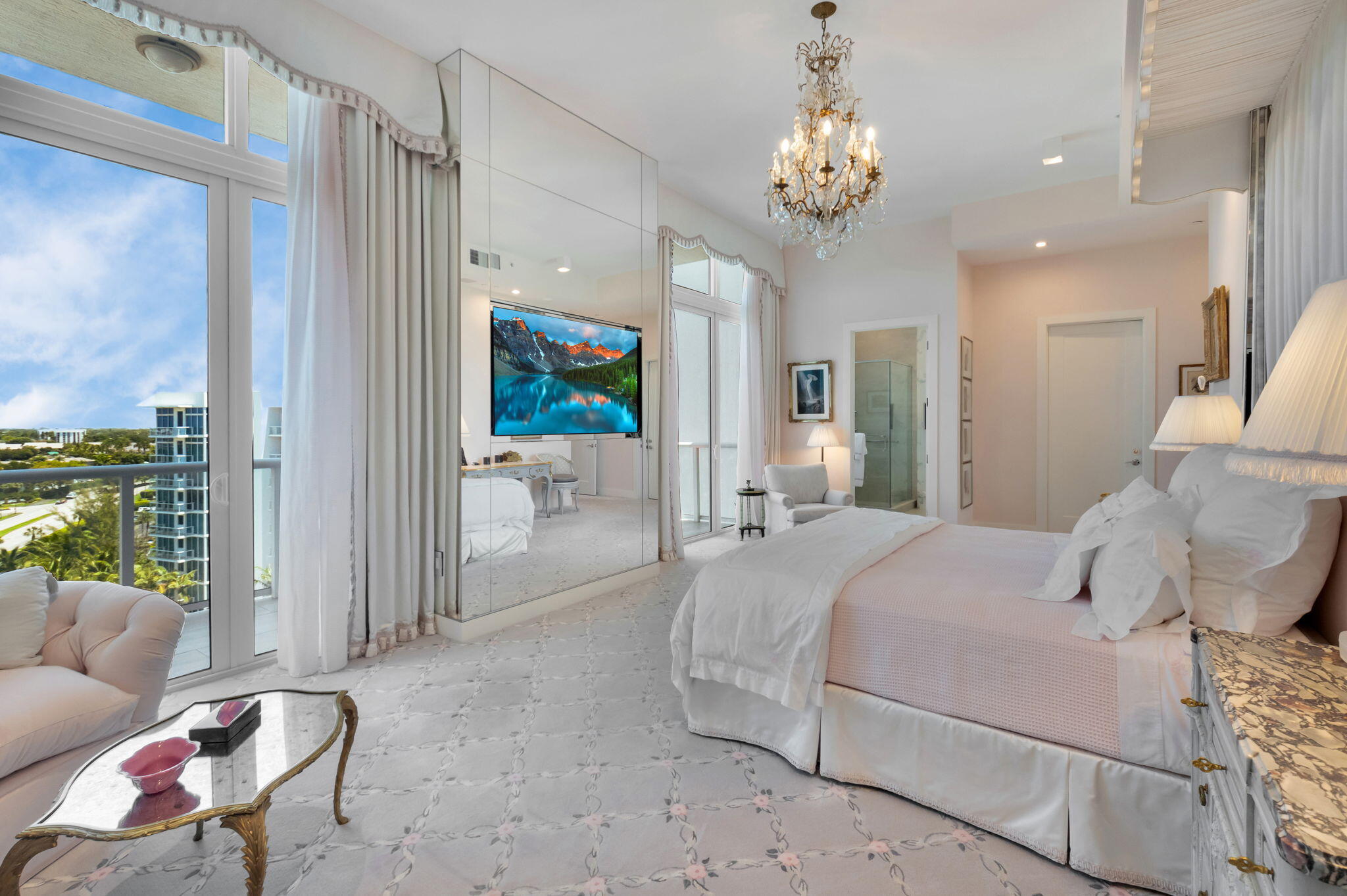 20155 Boca W Drive, Unit PHC902 Boca Raton, FL 33434 - Photo 18 of 56 a bedroom with a large bed and a chandelier