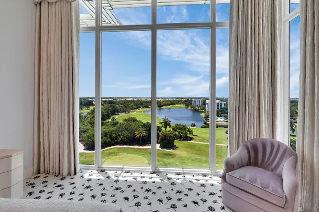 a dining room with furniture and a floor to ceiling window