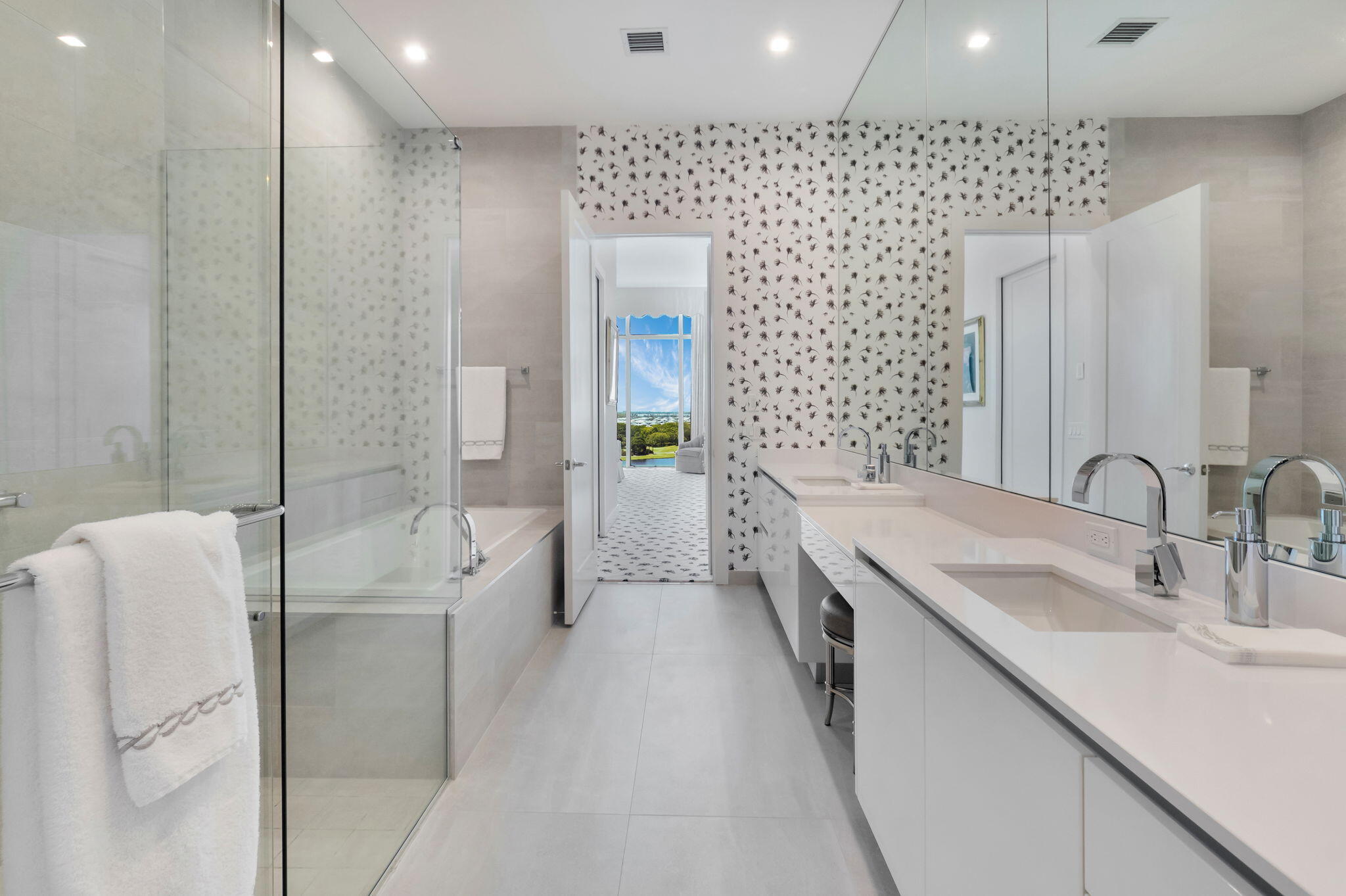 20155 Boca W Drive, Unit PHC902 Boca Raton, FL 33434 - Photo 27 of 56 a spacious bathroom with a double vanity sink a mirror and a bathtub