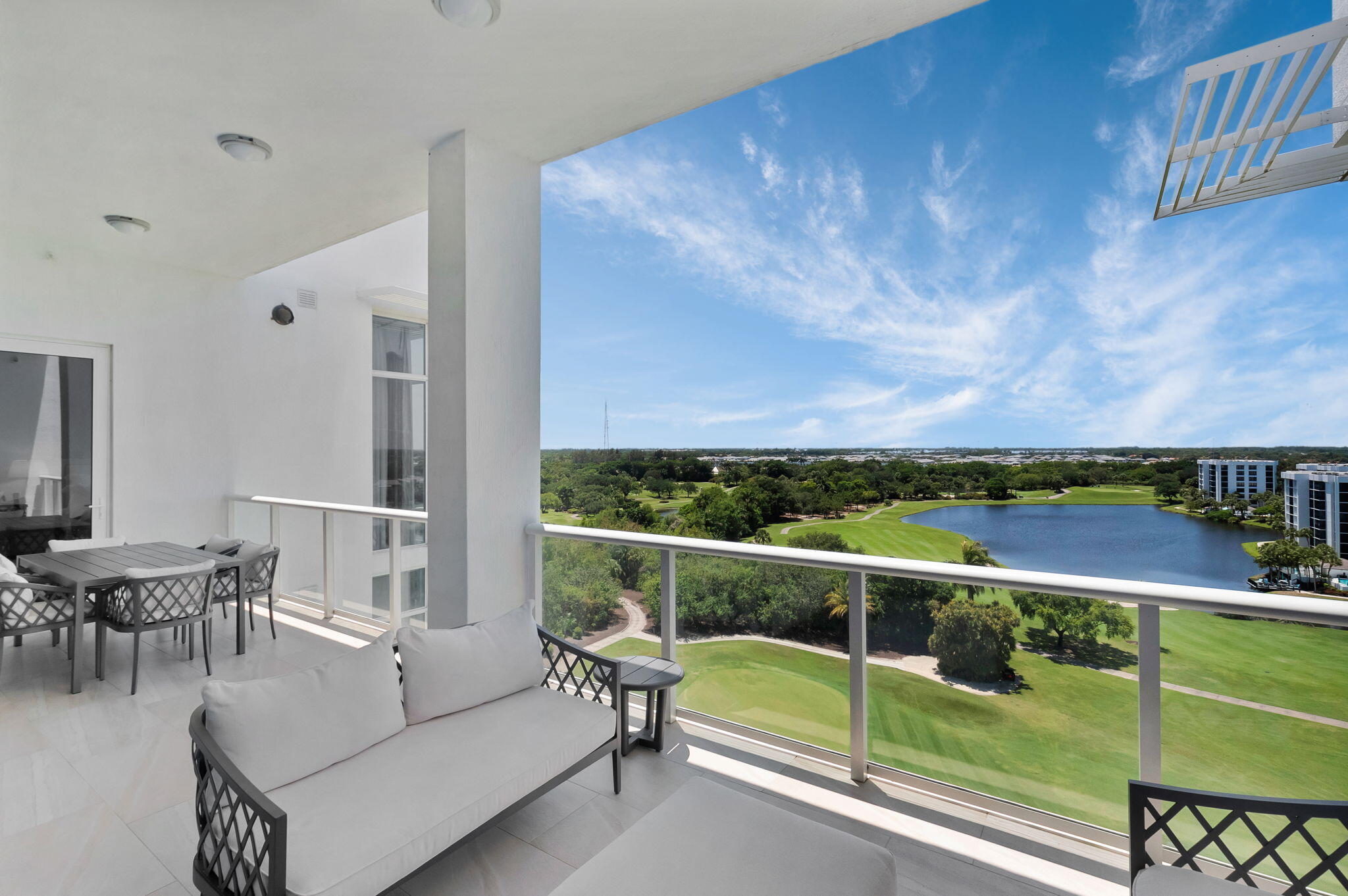 20155 Boca W Drive, Unit PHC902 Boca Raton, FL 33434 - Photo 32 of 56 a view of a chairs and table on the terrace