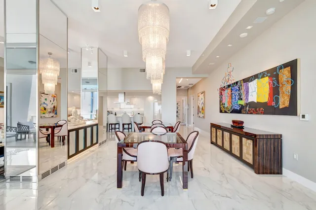 a dining area with furniture and a chandelier