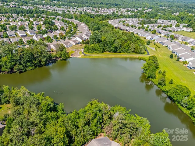 an aerial view of a houses with a lake view