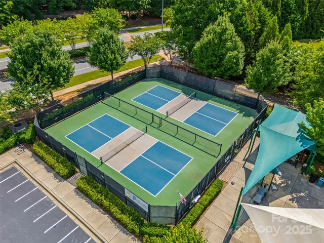 an aerial view of a tennis ground with a small yard