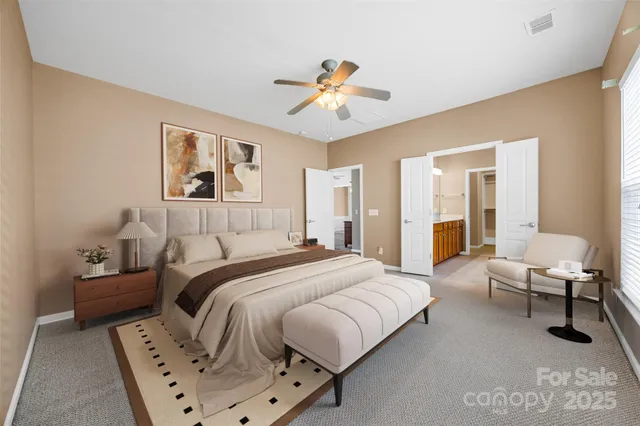 a spacious bedroom with a bed and a chandelier