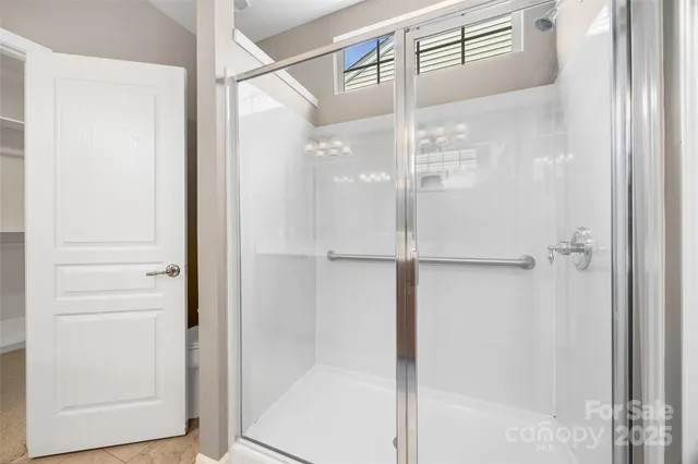 a bathroom with a glass shower door