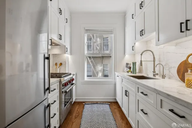 a kitchen with granite countertop a stove and a sink