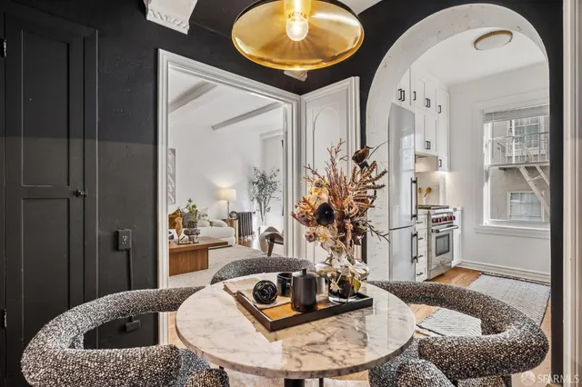 a living room with furniture and a mirror