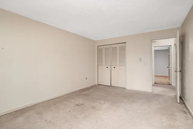 a view of an empty room and closet area