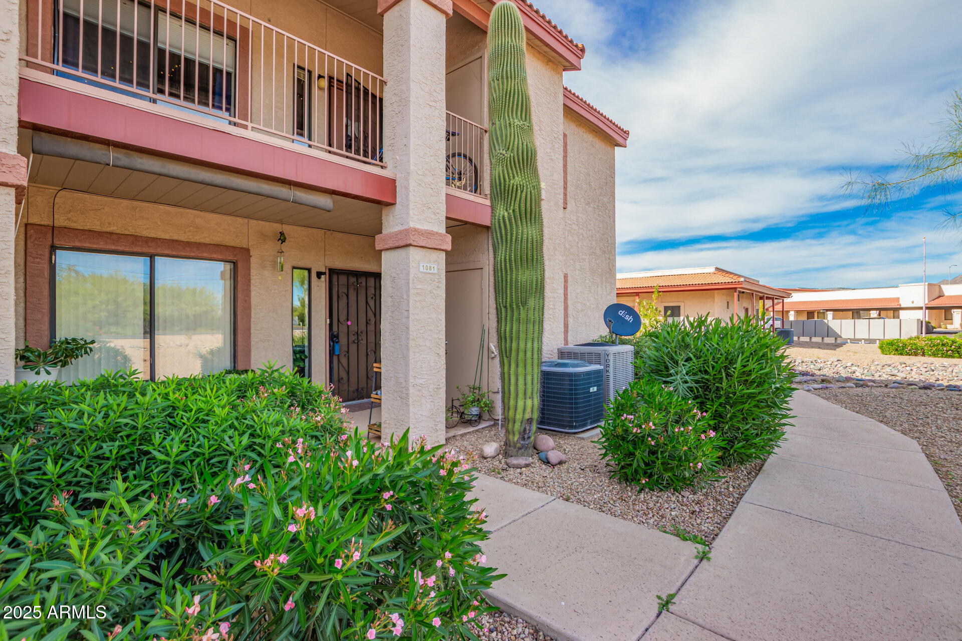 1440 North Idaho Road, Unit 1081 Apache Junction, AZ 85119 - Photo 1 of 33 a front view of a building with a garden