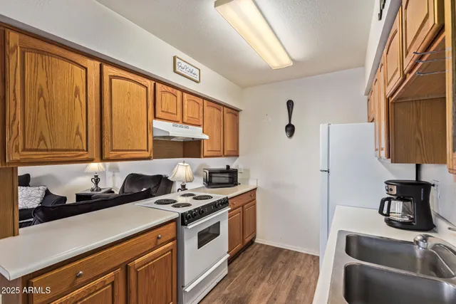 a kitchen with stainless steel appliances a sink a stove and a refrigerator
