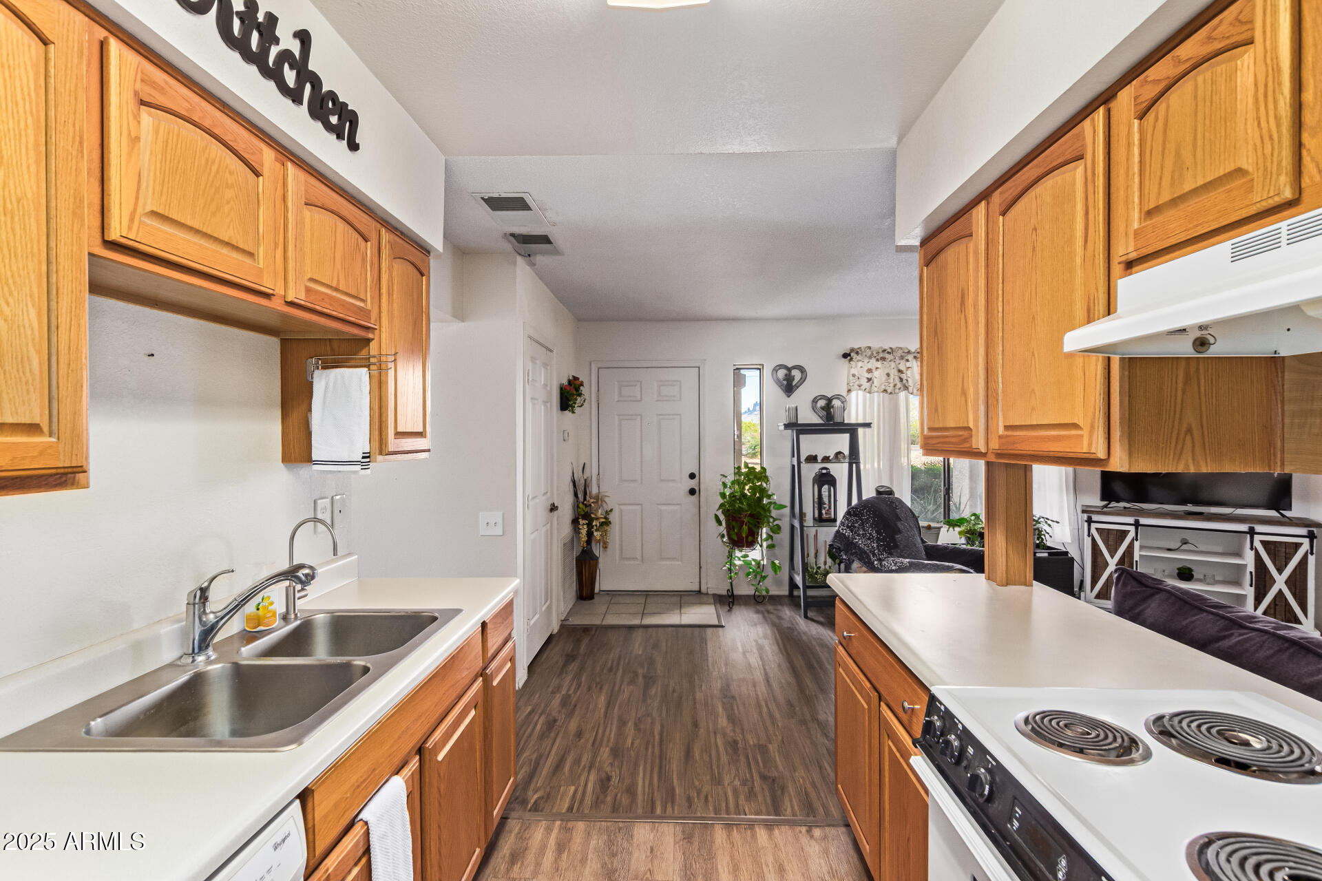 1440 North Idaho Road, Unit 1081 Apache Junction, AZ 85119 - Photo 13 of 33 a kitchen with a sink a stove and wooden cabinets