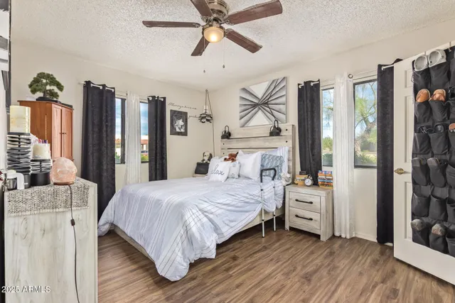 a bedroom with a bed and a chandelier