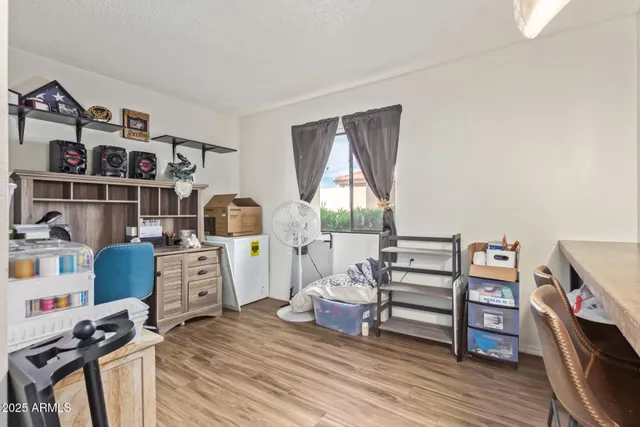 a view of a workspace with furniture and wooden floor