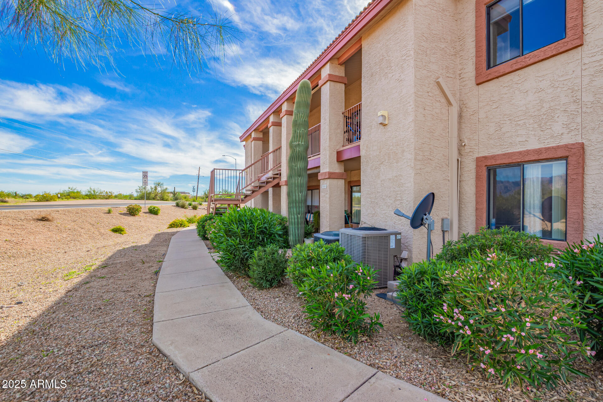 1440 North Idaho Road, Unit 1081 Apache Junction, AZ 85119 - Photo 2 of 33 a view of a patio with lawn chairs under an umbrella