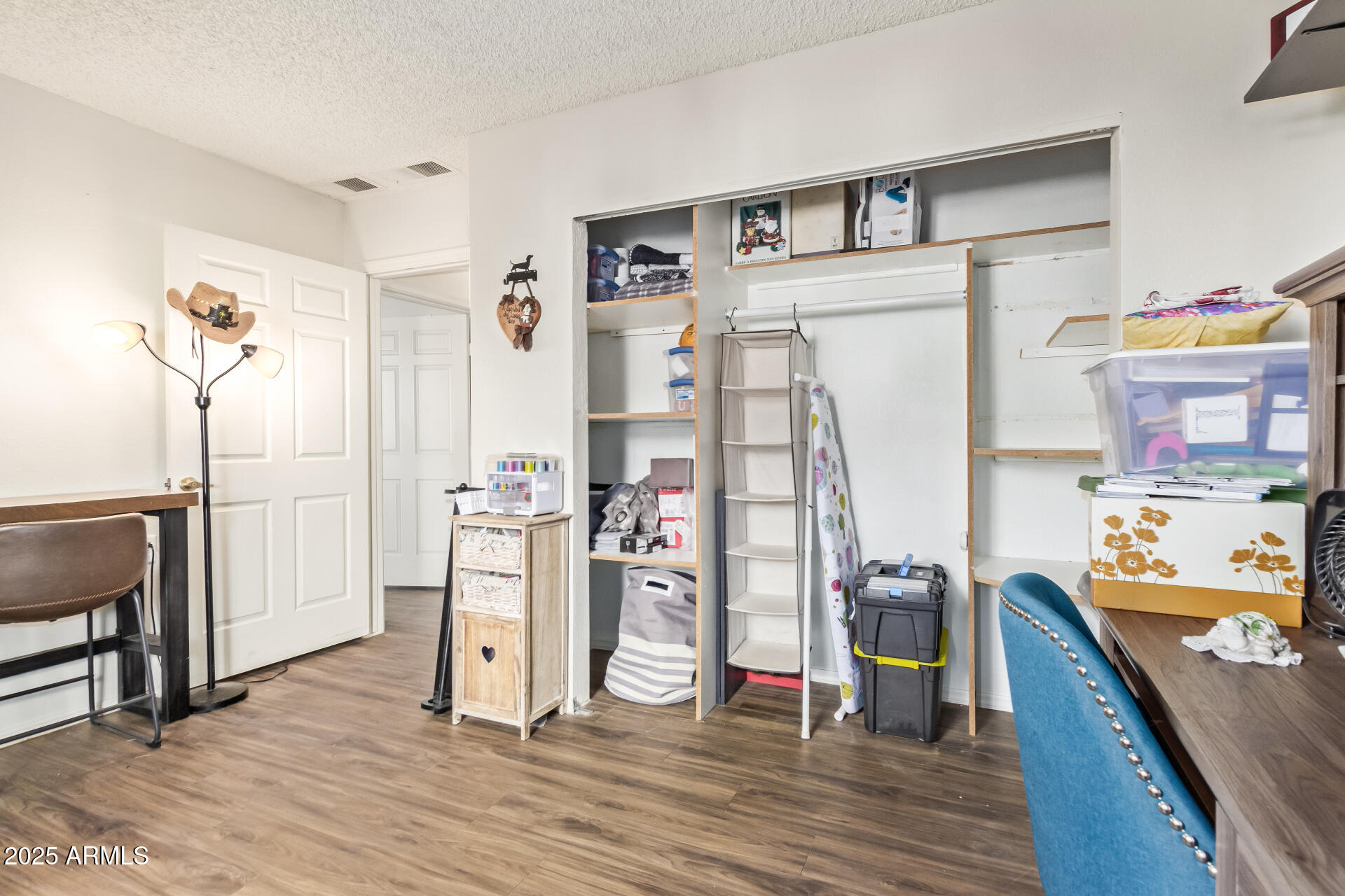 1440 North Idaho Road, Unit 1081 Apache Junction, AZ 85119 - Photo 21 of 33 a view of a bedroom with workspace and wooden floor
