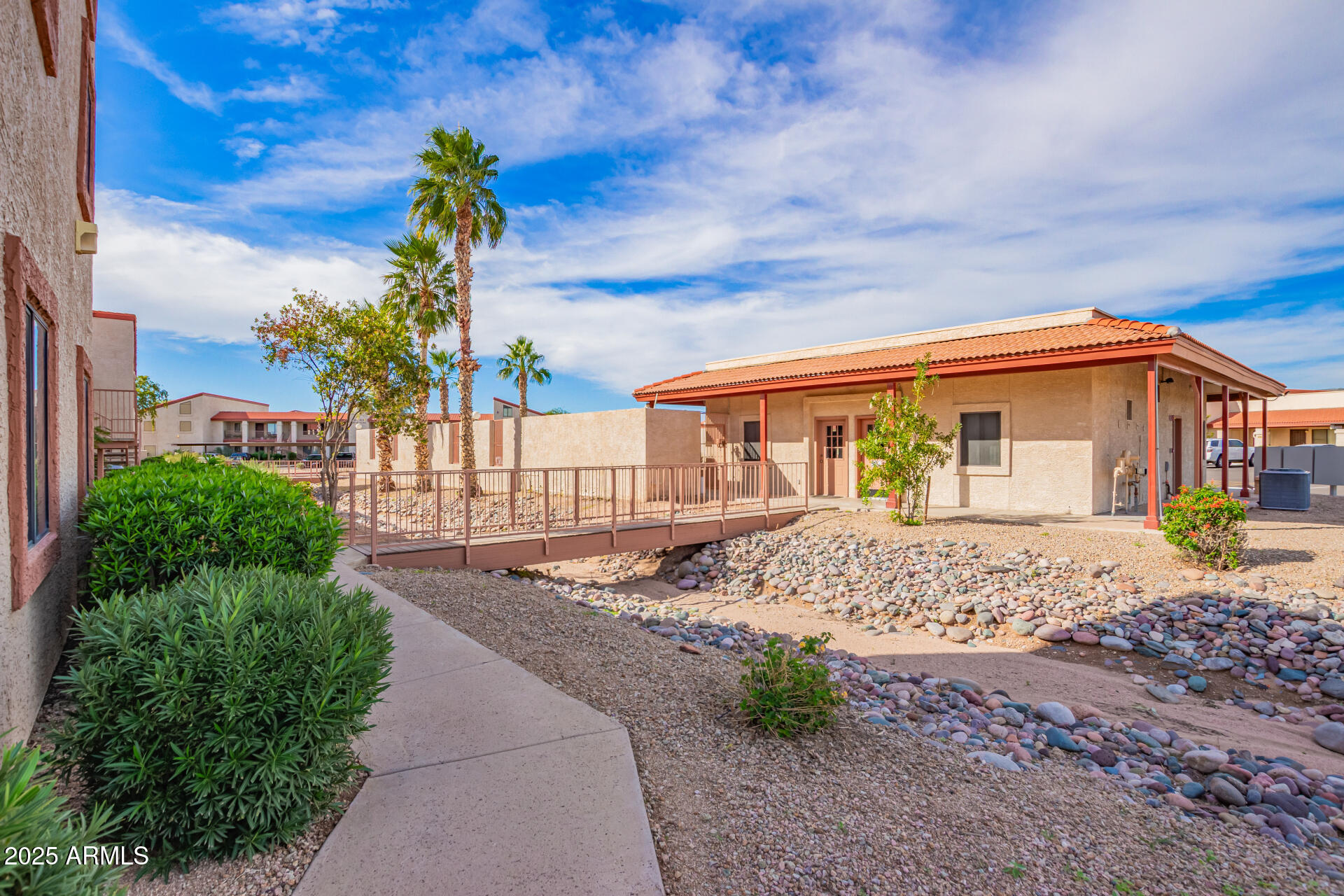 1440 North Idaho Road, Unit 1081 Apache Junction, AZ 85119 - Photo 28 of 33 a front view of a house with a garden