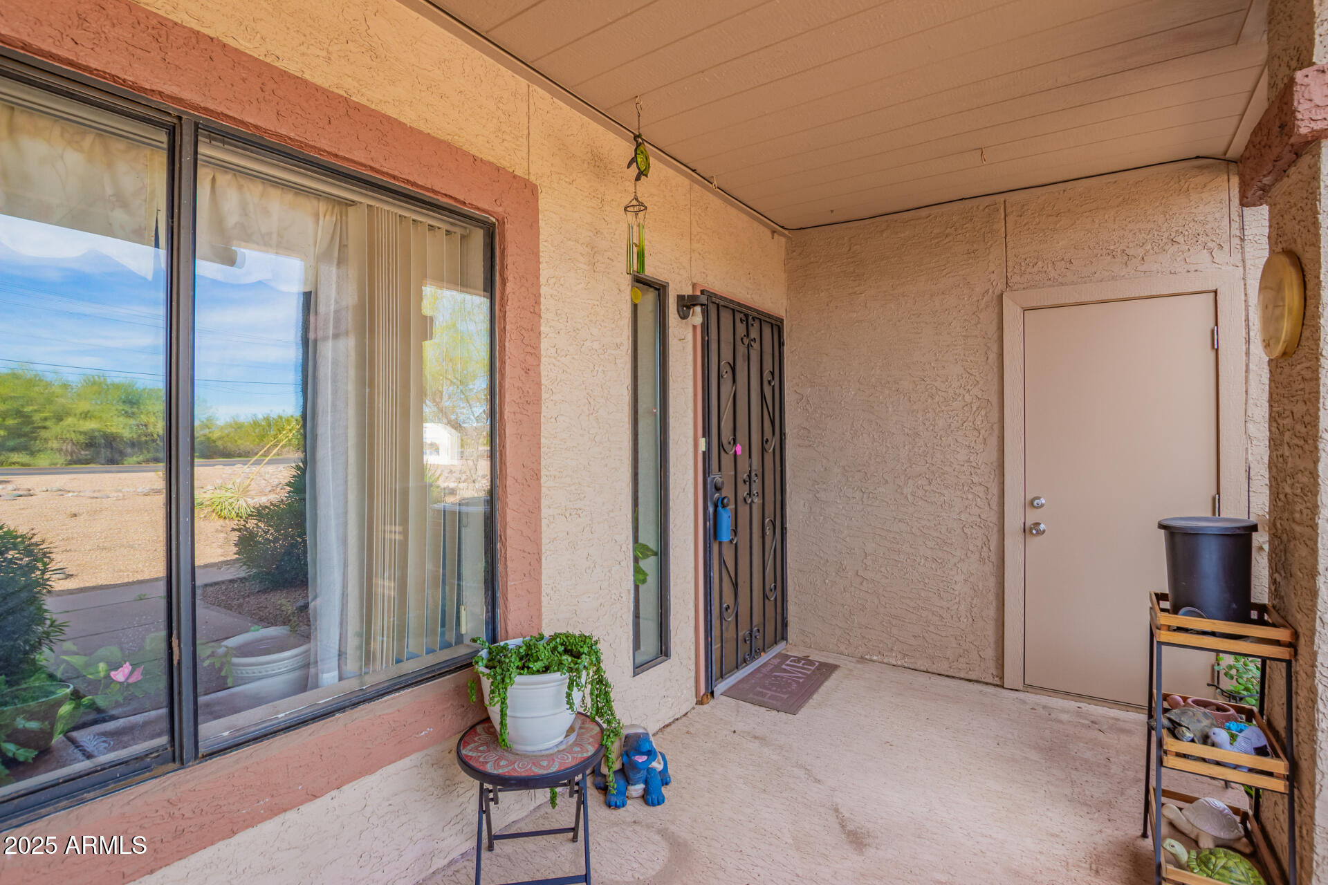 1440 North Idaho Road, Unit 1081 Apache Junction, AZ 85119 - Photo 5 of 33 a balcony with furniture and a potted plant